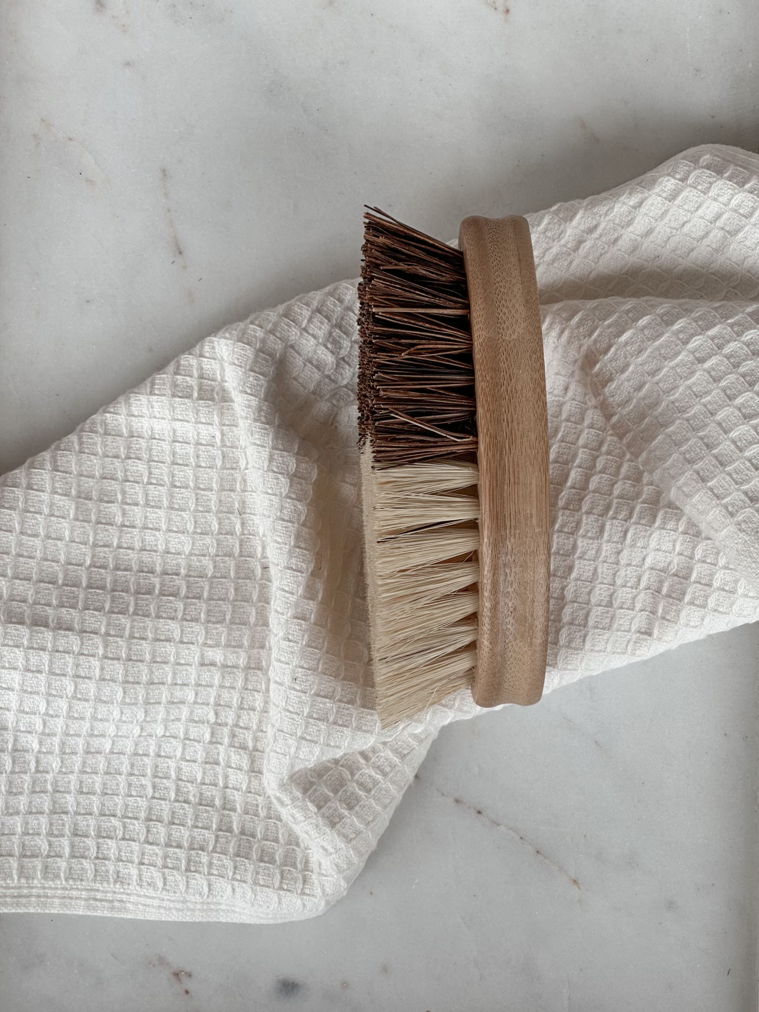 Oval Coconut fiber cleaning brush with an ivory towel