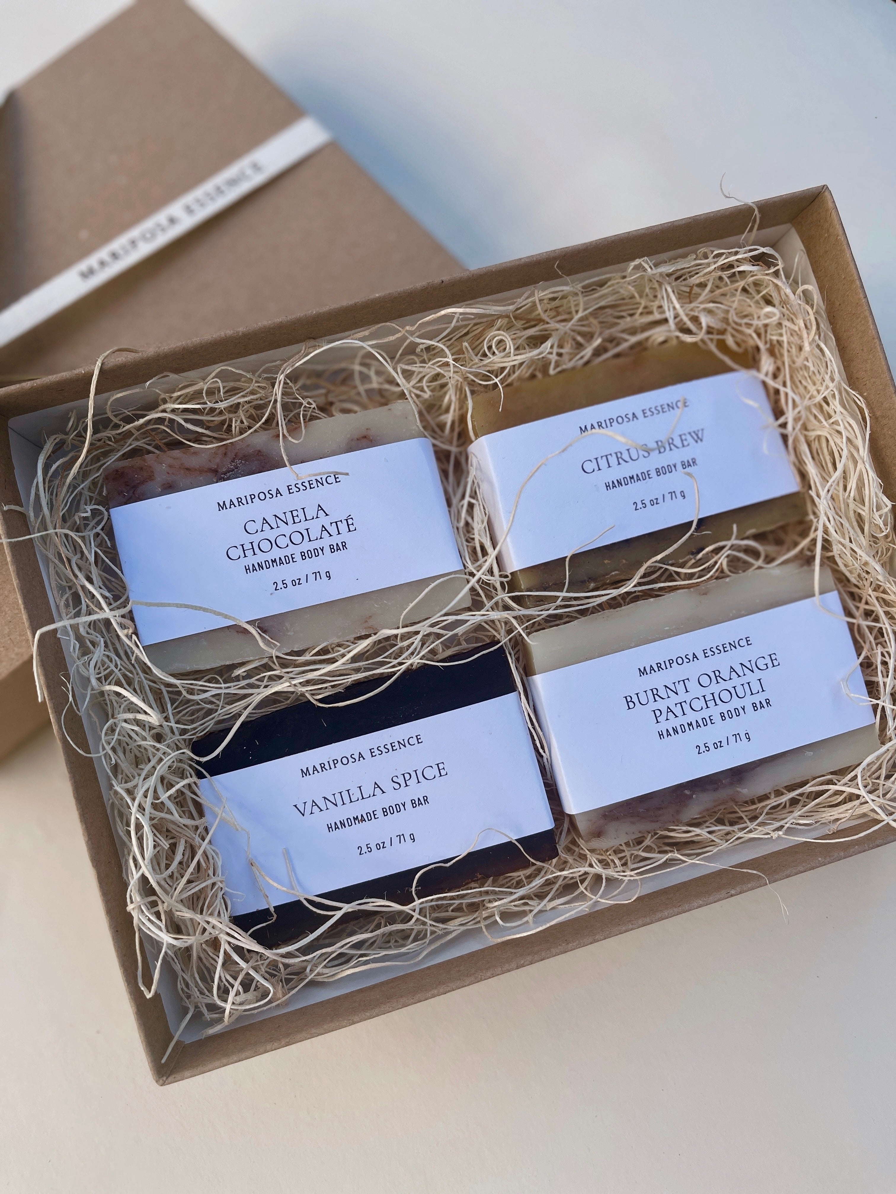 box of four soap samplers in natural filler and a kraft box.