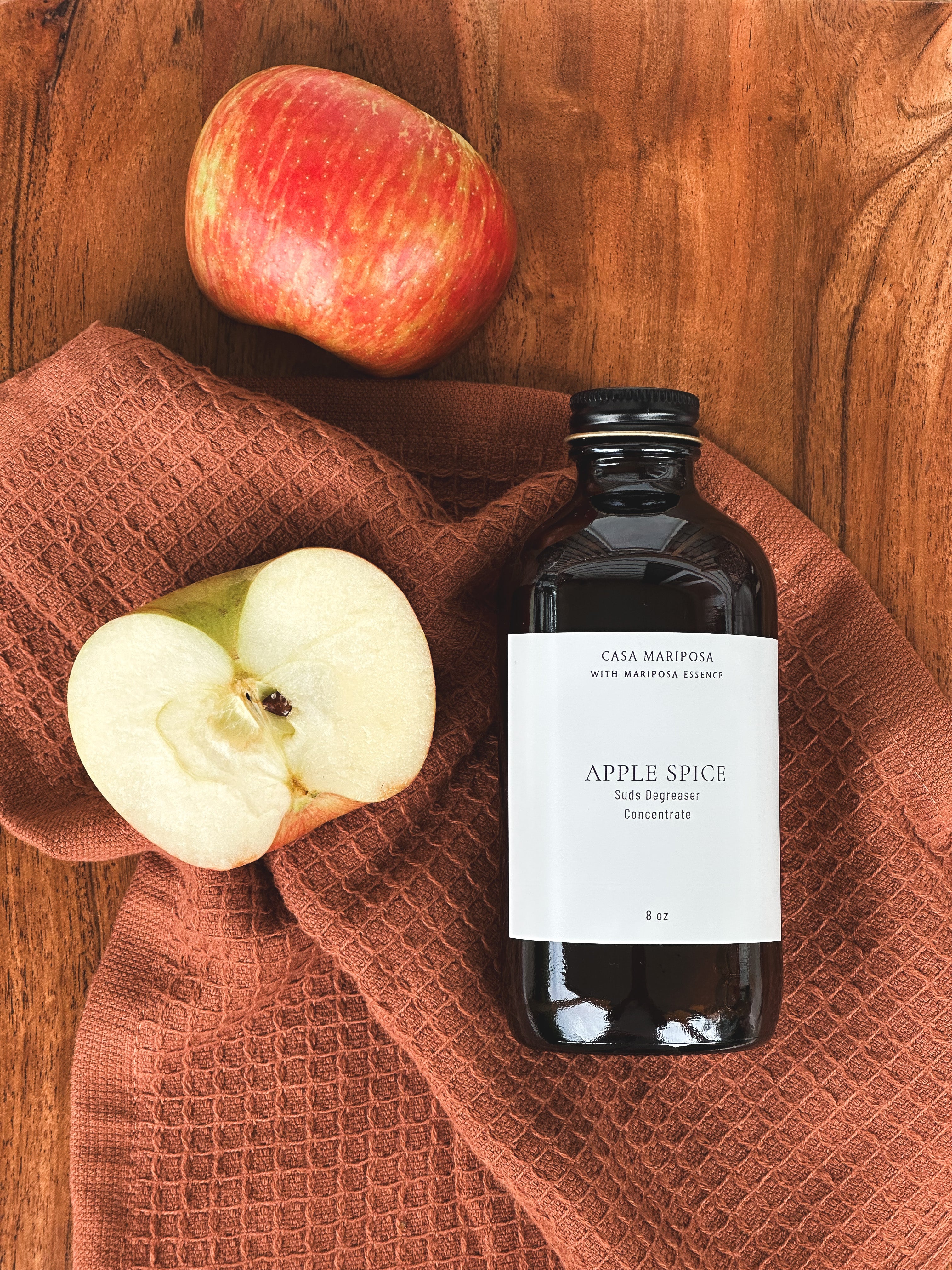 Apple Spice suds degreaser displayed with apples.