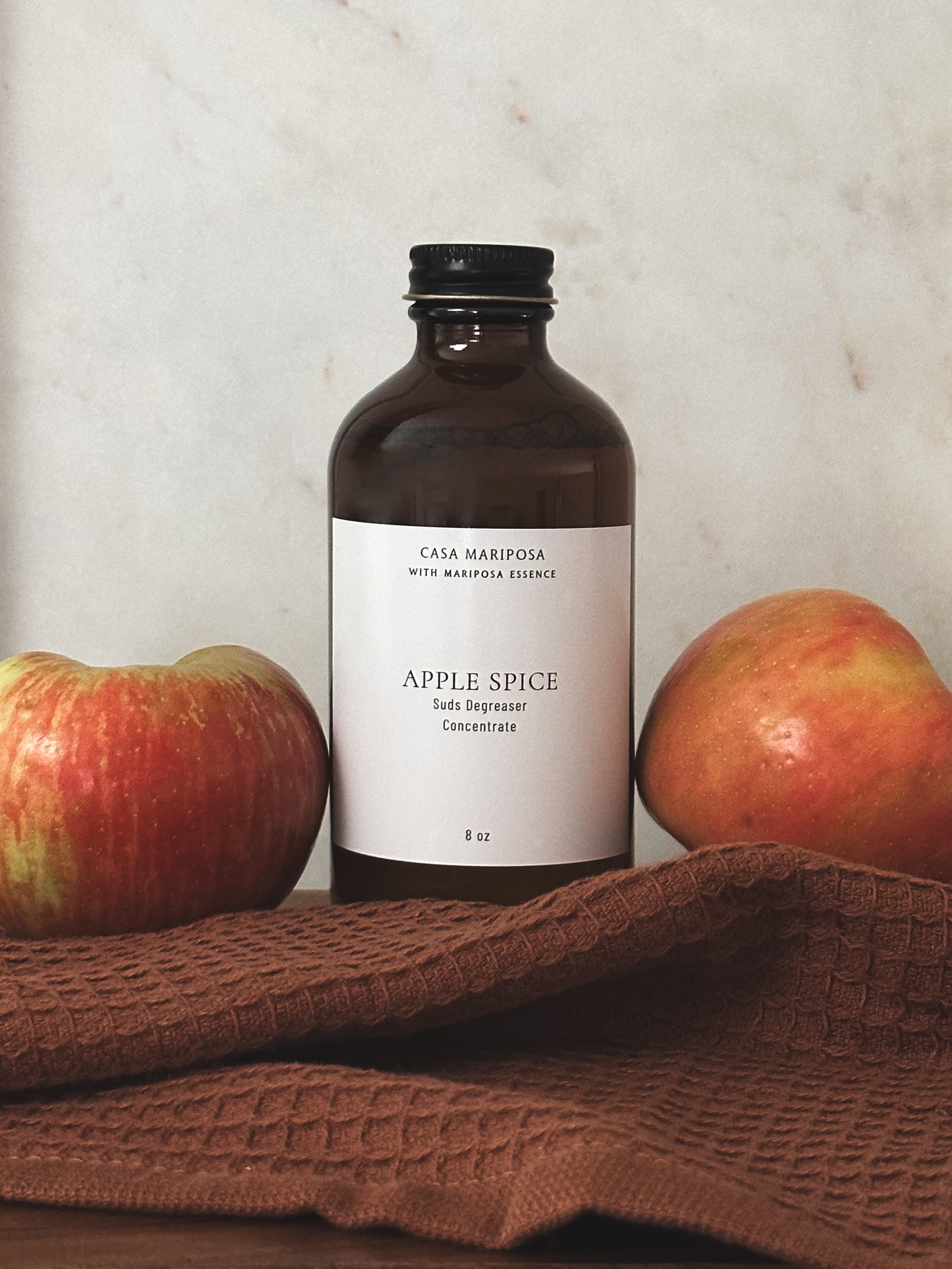 Apple Spice suds degreaser displayed with apples.