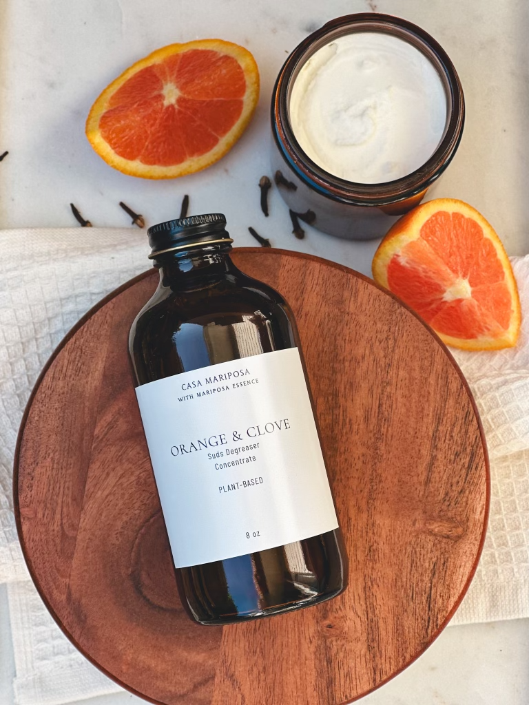 Orange & Clove Suds Duo displayed with oranges and cloves