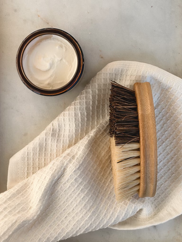 Orange + Clove Suds Scrub displayed with coconut cleaning brush
