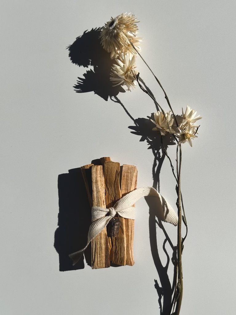 Palo Santo displayed with nana bell and dried floral.