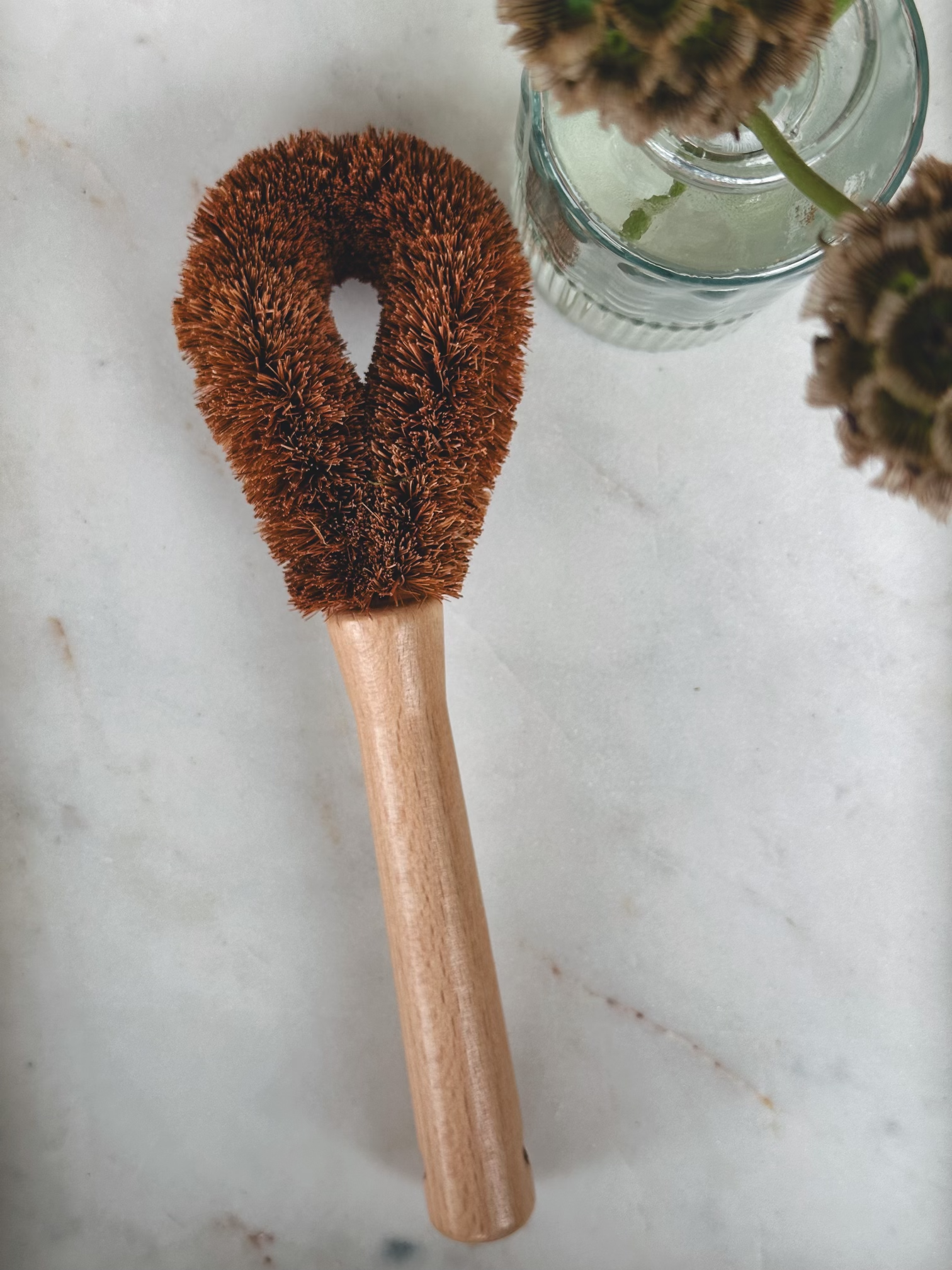 Pot brush displayed with flowers