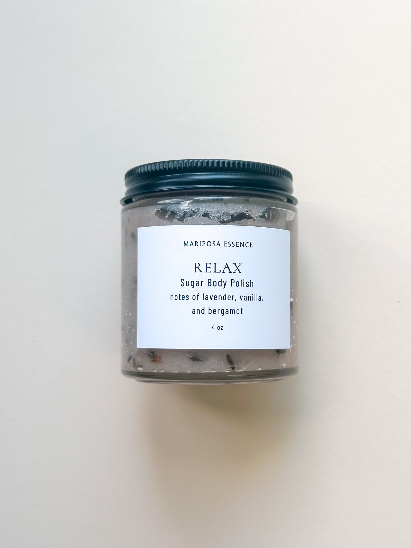 relax sugar body polish in a 4oz clear glass jar with a matte top.