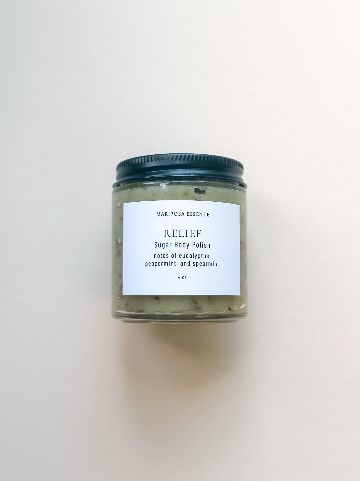 Relief Sugar Body Polish in a clear glass jar with a black matte cap.