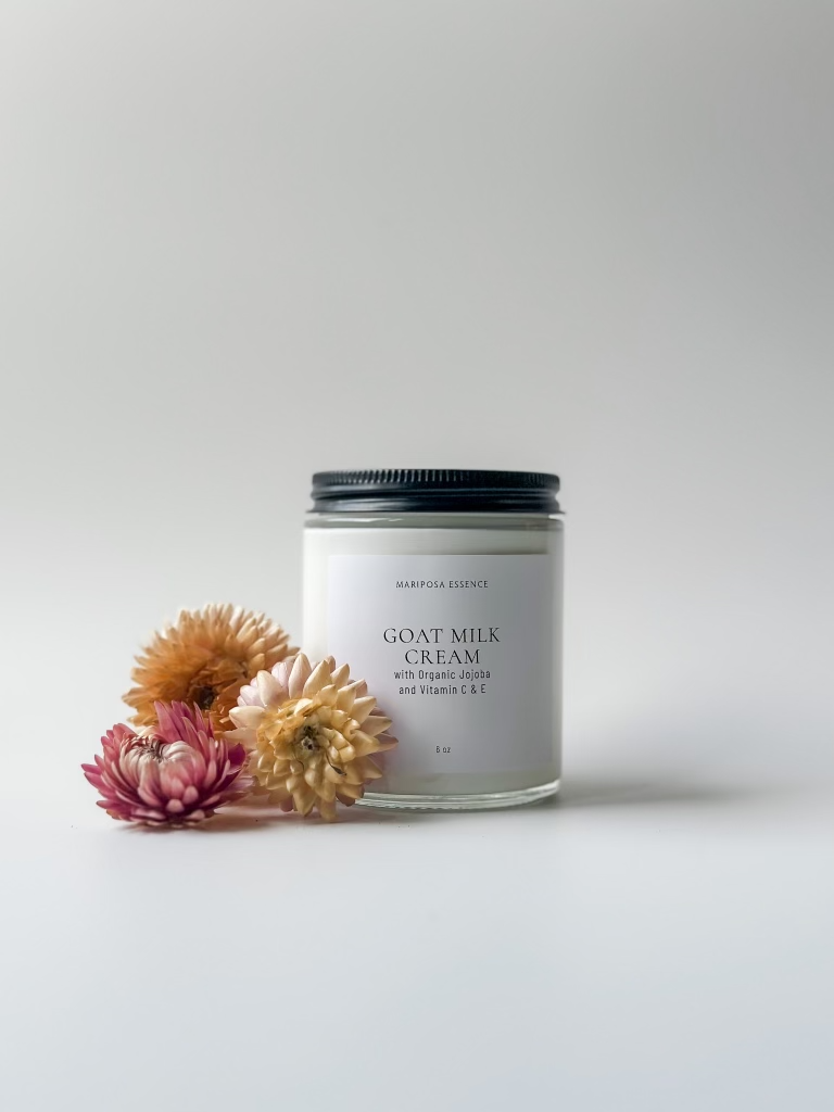 Goat milk cream displayed with florals.