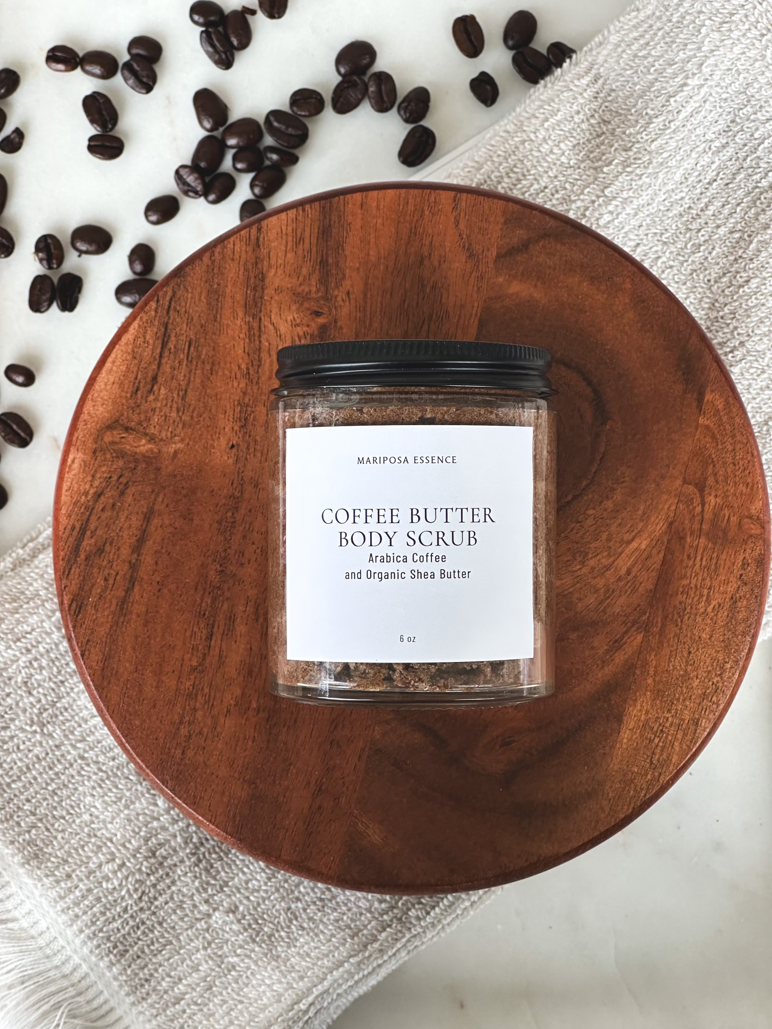 Coffee butter body scrub displayed with coffee beans