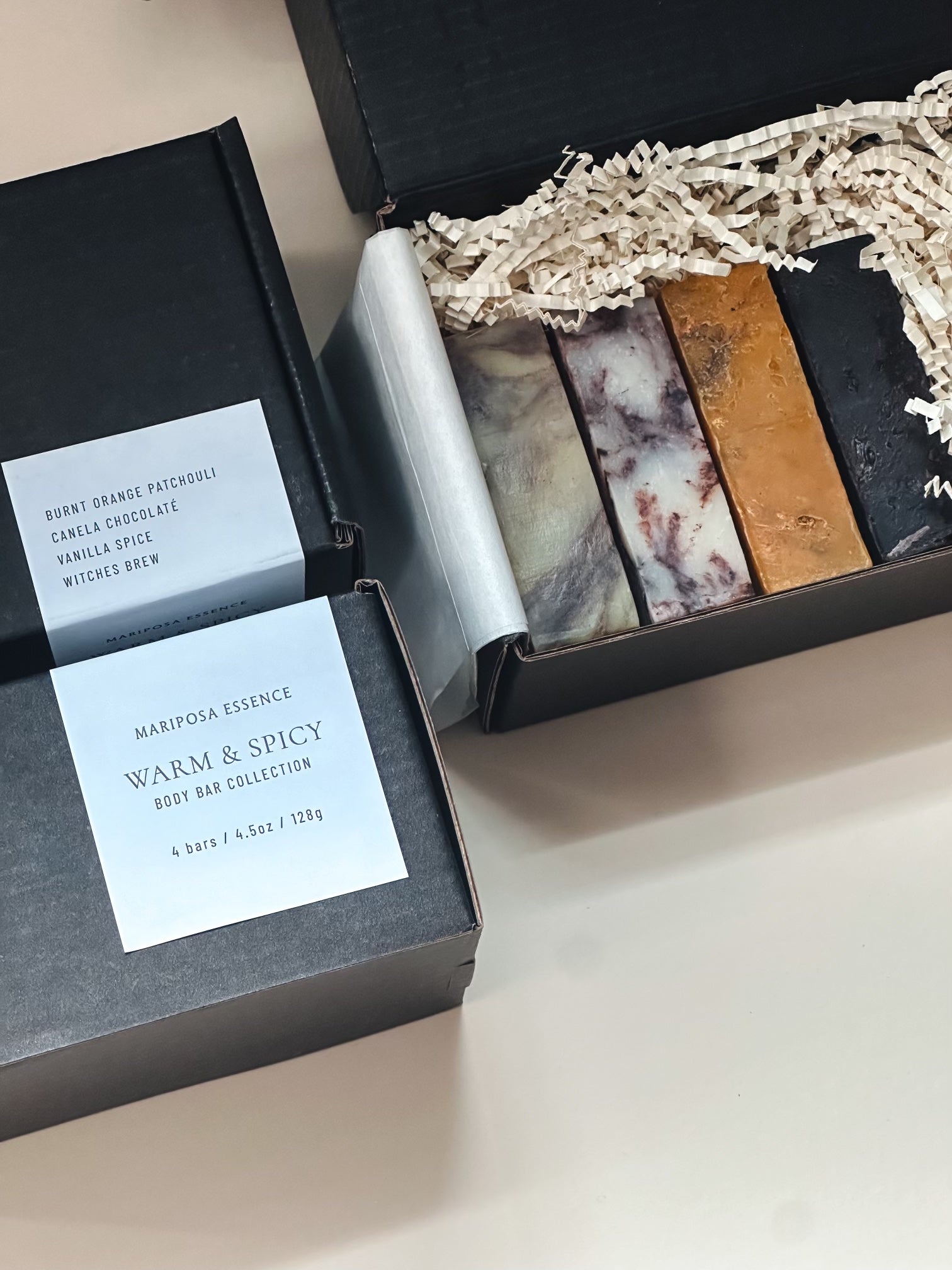 Warm and Spicy collection bars displayed in a black kraft box with tissue, crinkle and product label.