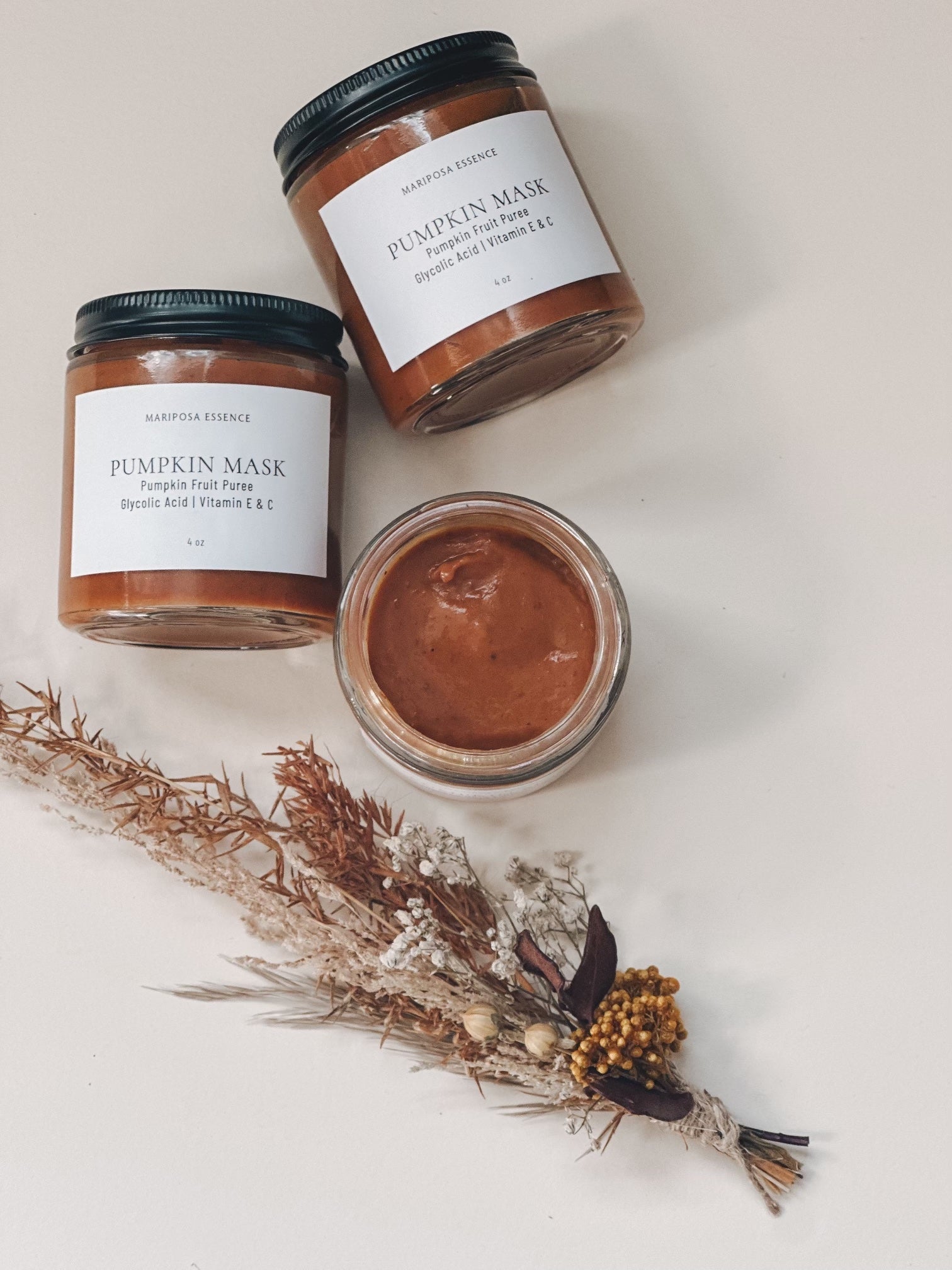 Pumpkin spice masks displayed with a bushel of dried florals.
