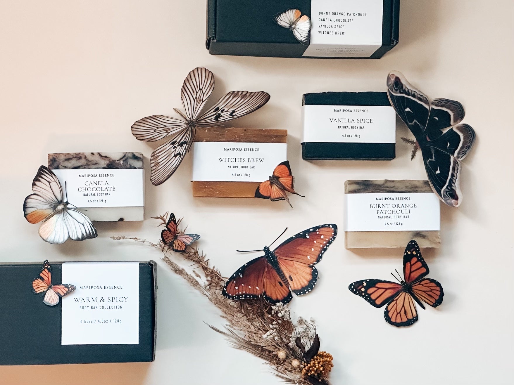 Warm and Spicy Collection; Burnt Orange Patchouli, Canela Chocolate, Witches Brew and Vanilla Spice bar soaps displayed with butterflies.