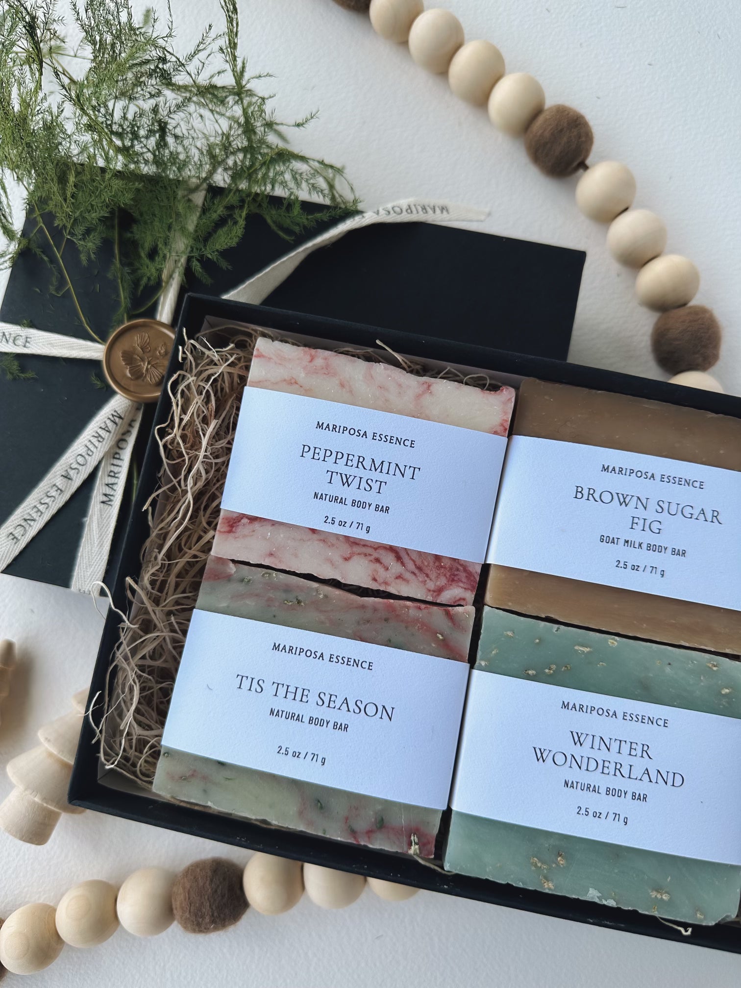 Tis the Season Body Bar sampler giftwrapped with butterfly gold seal and dried winter greens