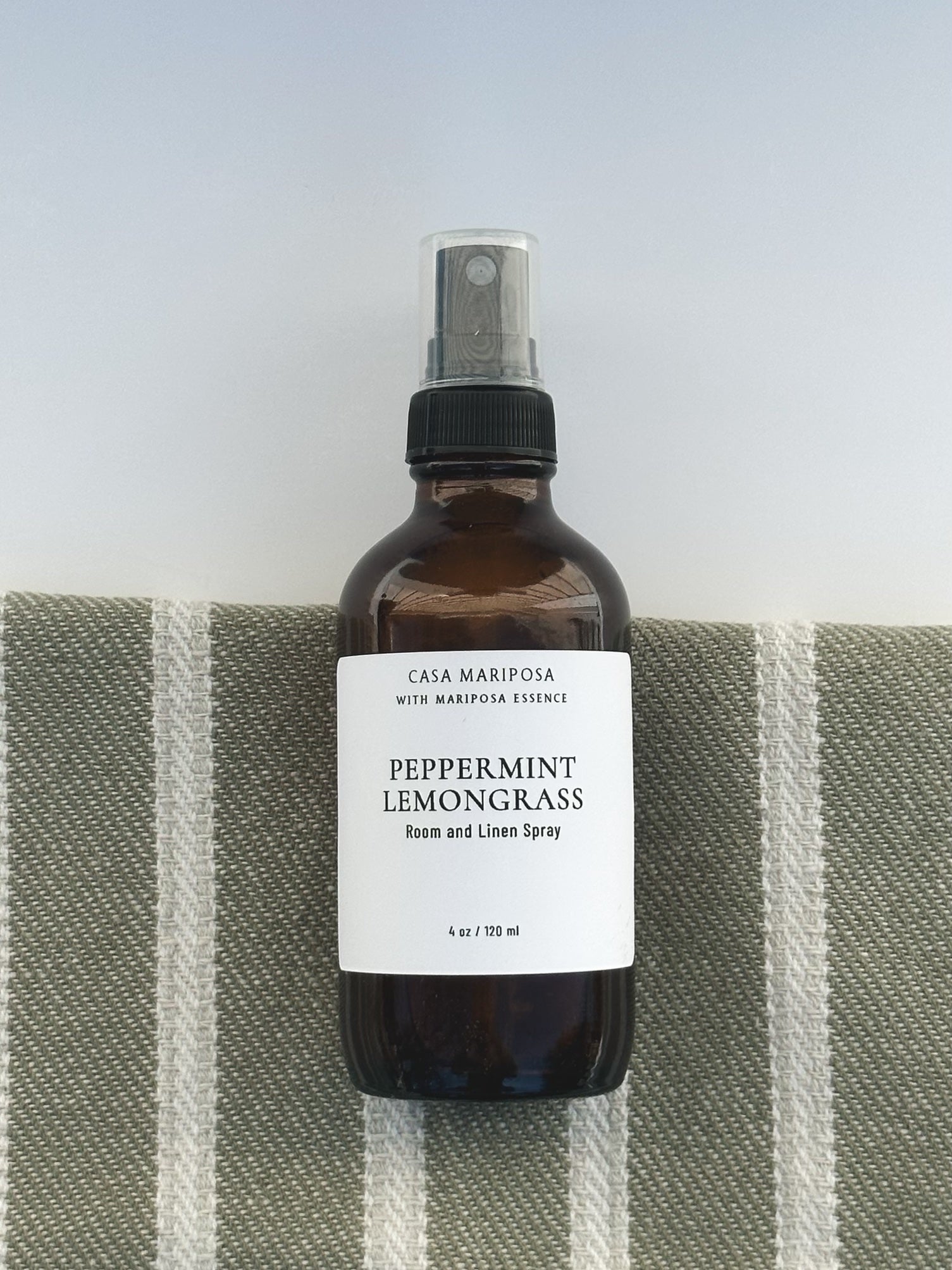 Peppermint Lemongrass Linen and Room Spray displayed with hand towel 