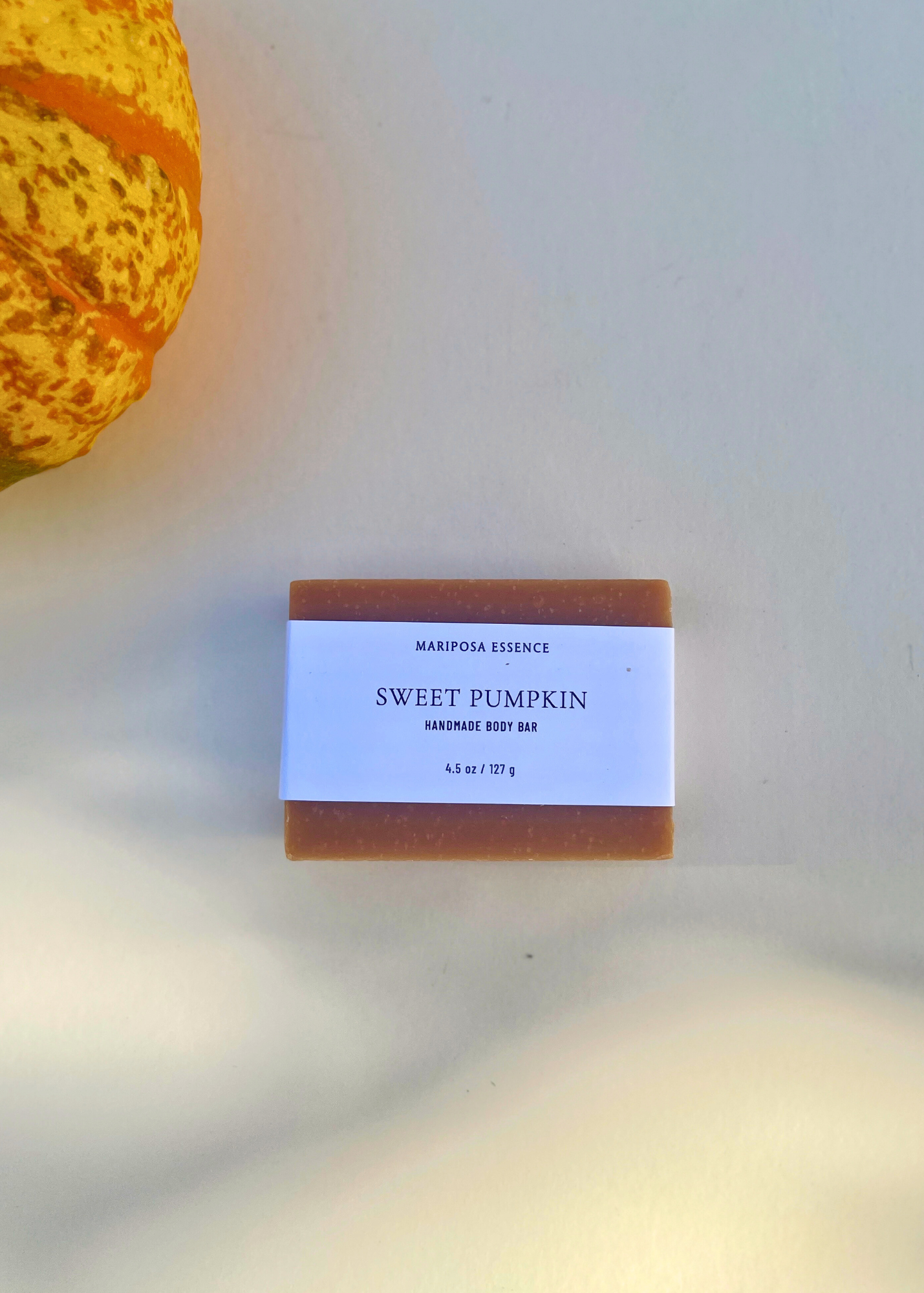 Bar of soap labeled 'Sweet Pumpkin' with a decorative pumpkin in the background.
